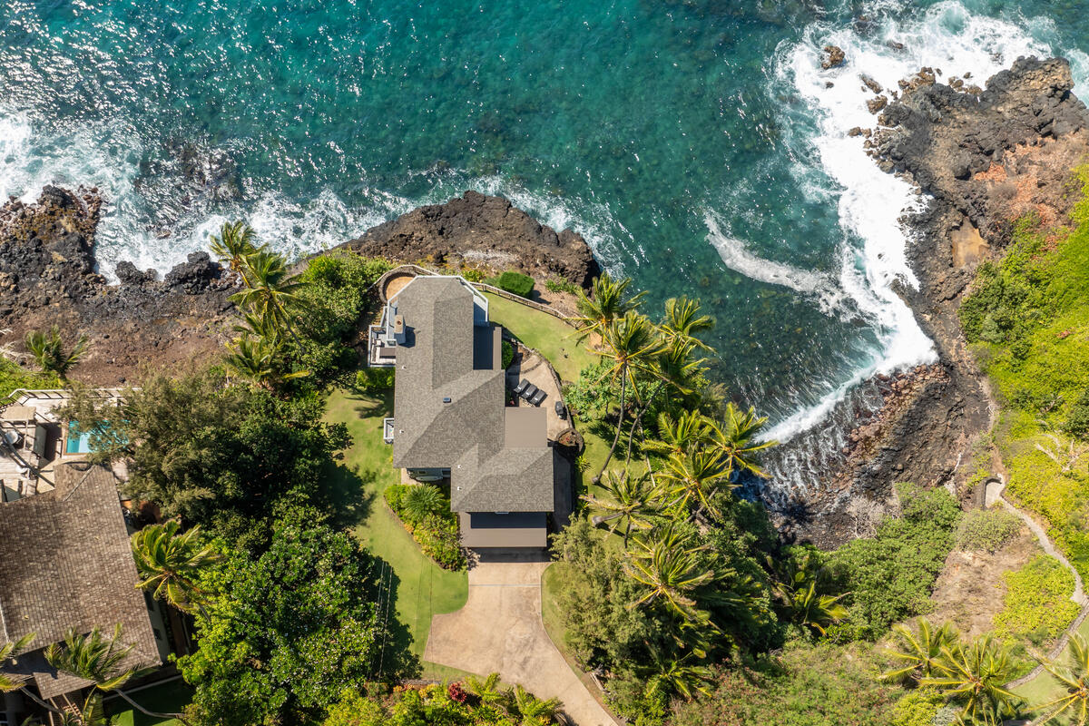 an aerial view of a house with a yard basket ball court