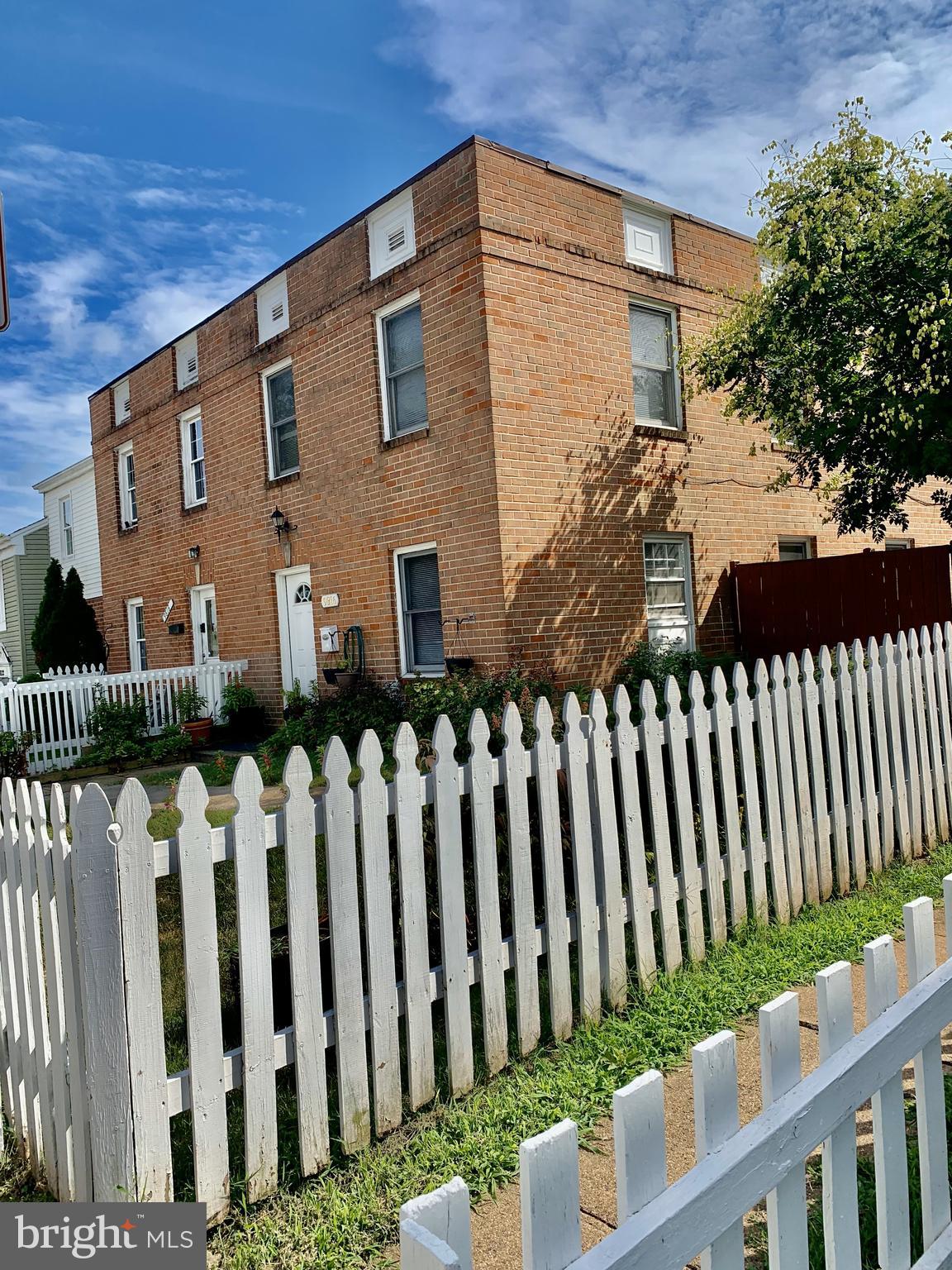 a view of a house with wooden fence