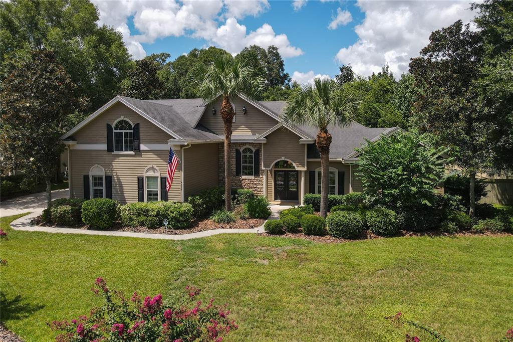 a front view of a house with a garden