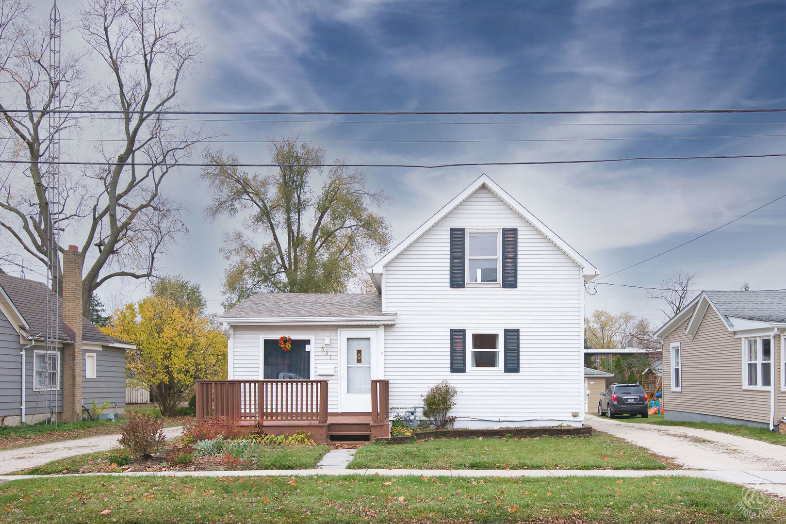 a front view of house with yard and green space