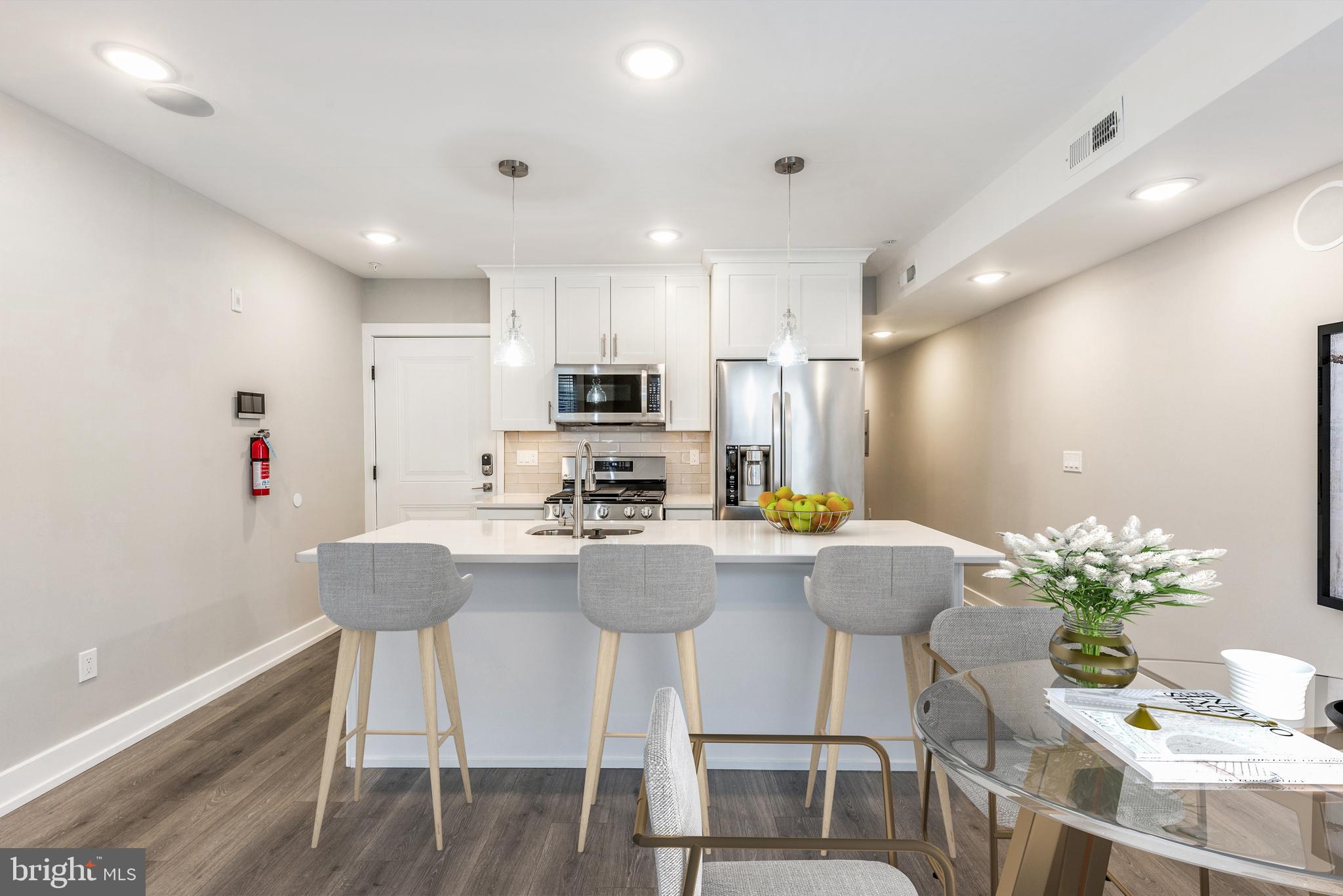 a kitchen that has a table and chairs in it