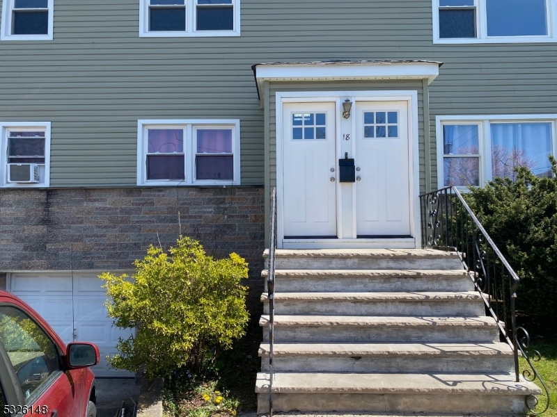 a front view of a house with potted plants