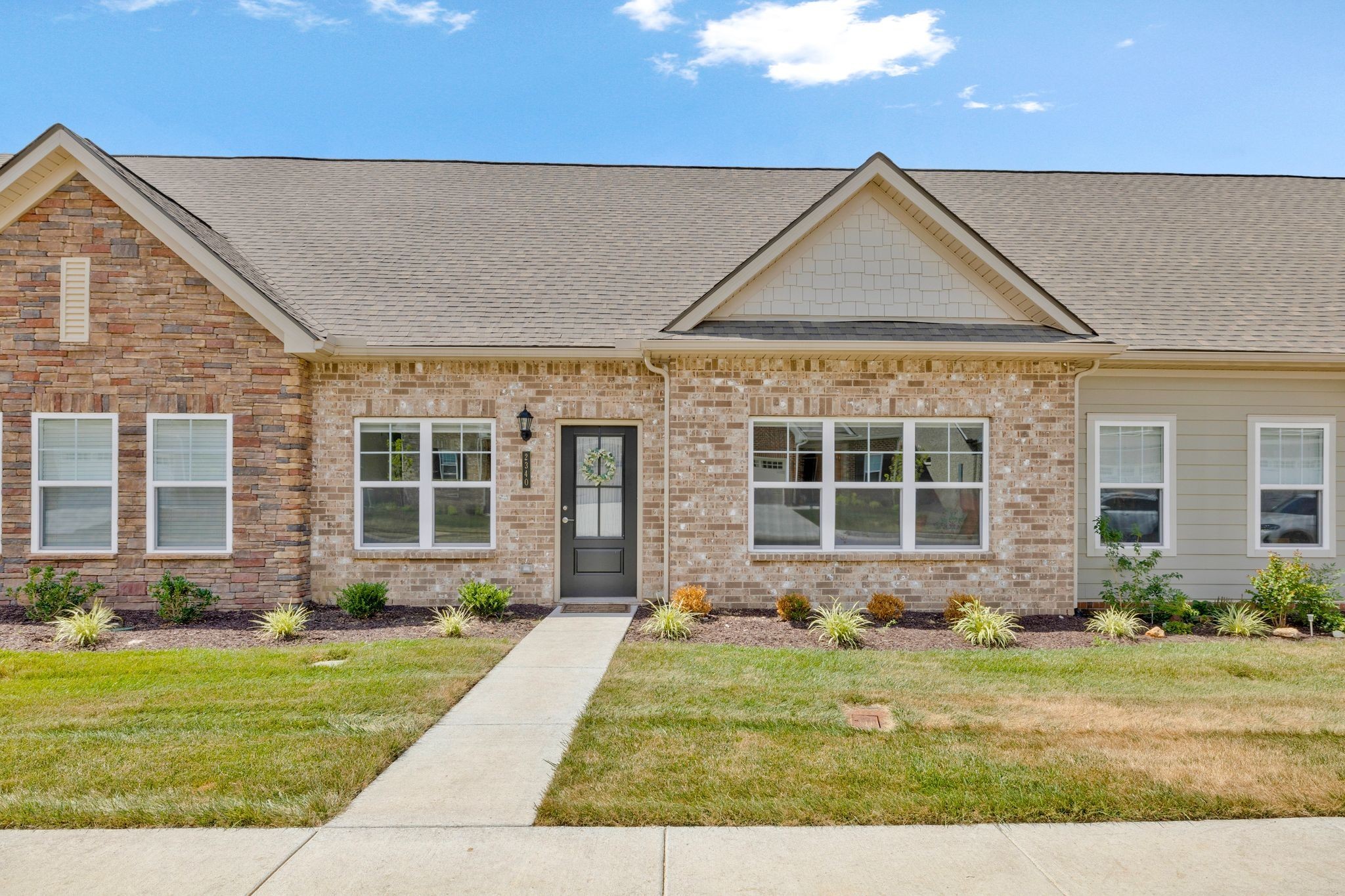 a front view of a house with a yard