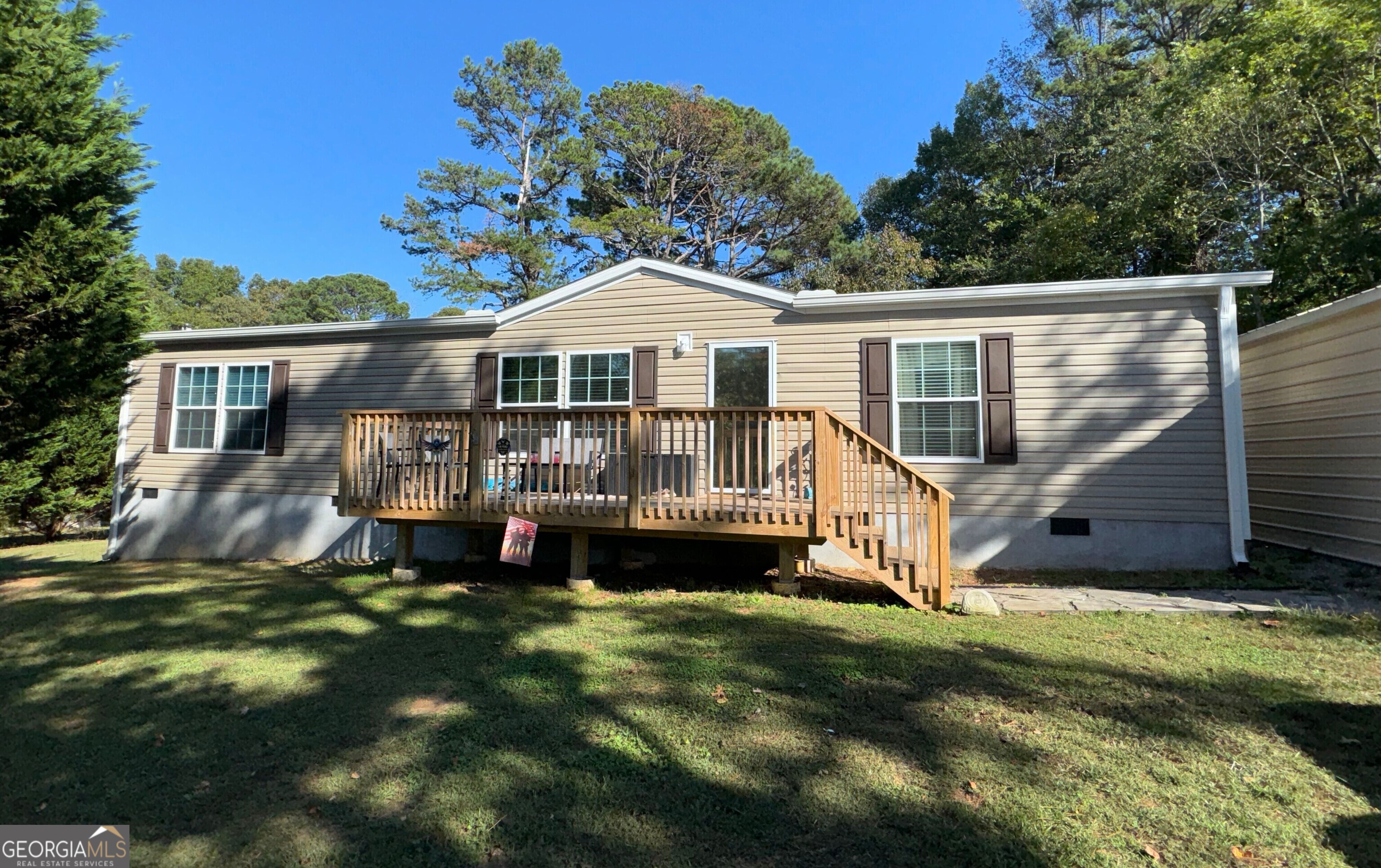 a front view of a house with a yard table and chairs