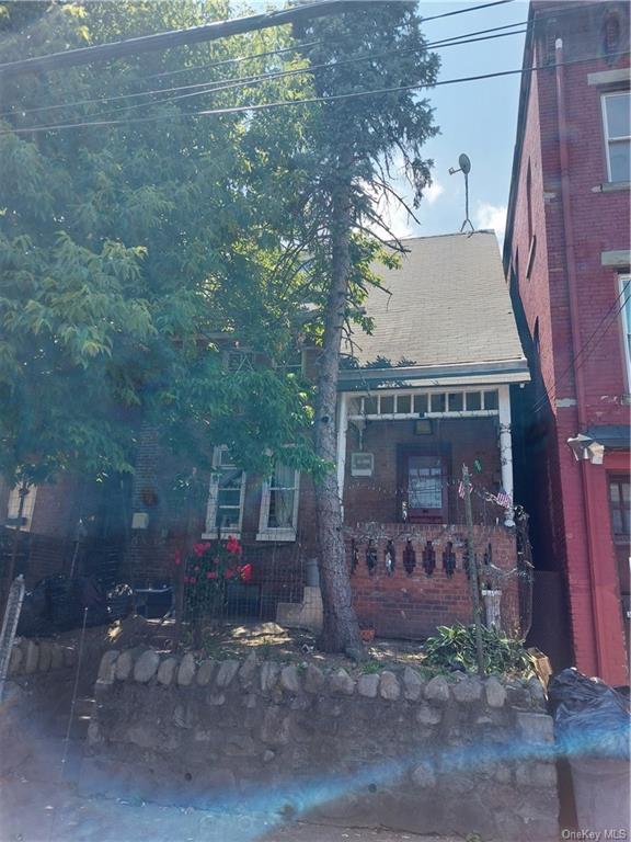 a view of a brick house with a yard