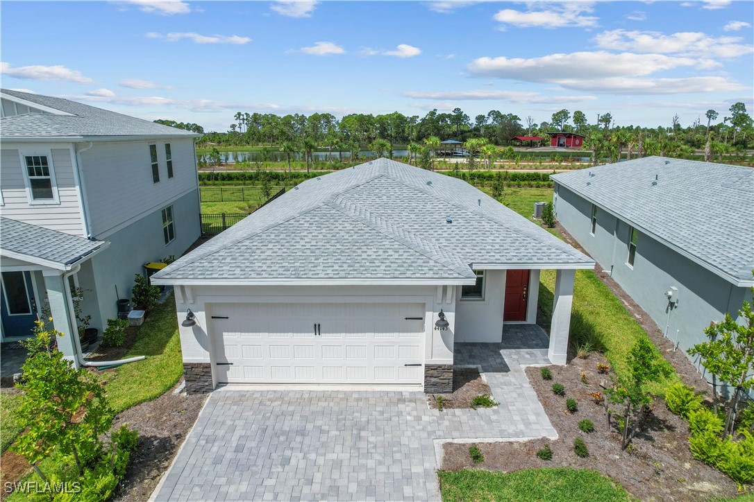 a aerial view of a house with a yard and potted plants