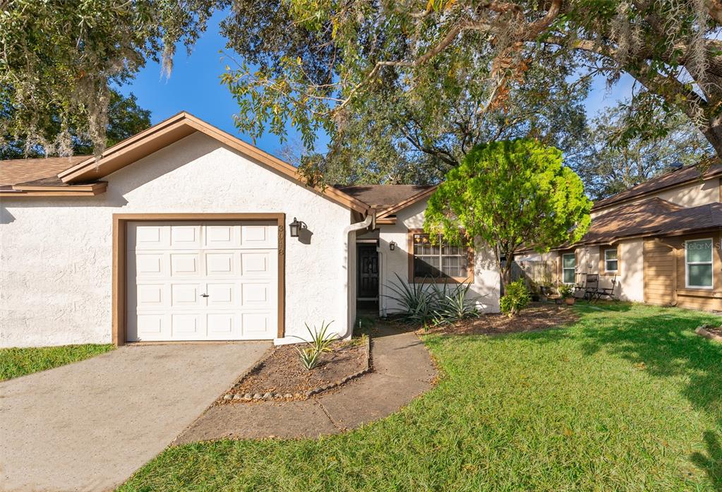 a view of a house with a yard and garage