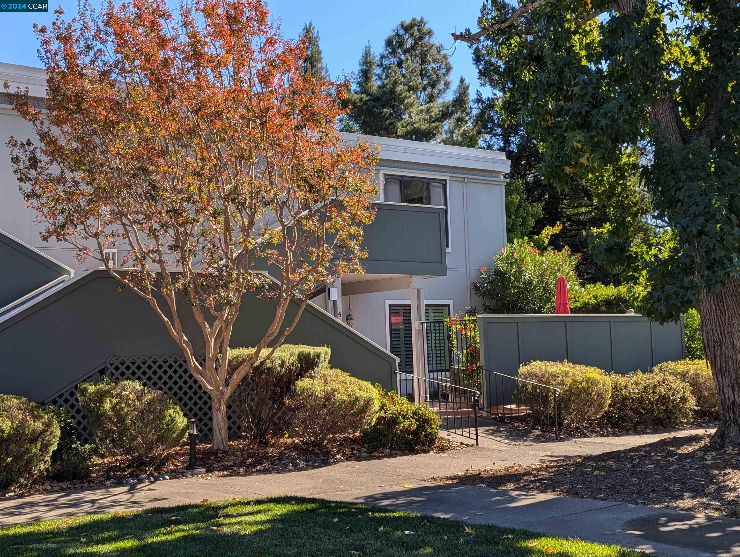 a view of a house with backyard and sitting area