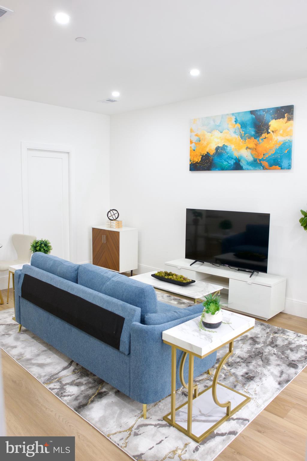 a living room with furniture and a flat screen tv