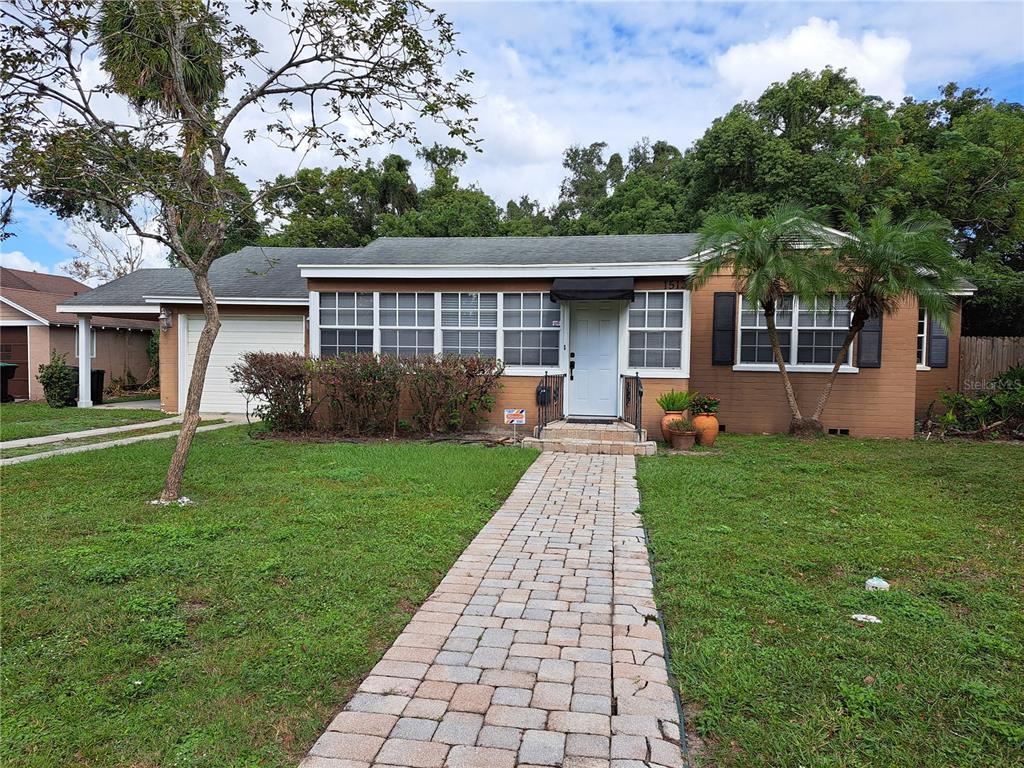 a front view of house with yard and green space