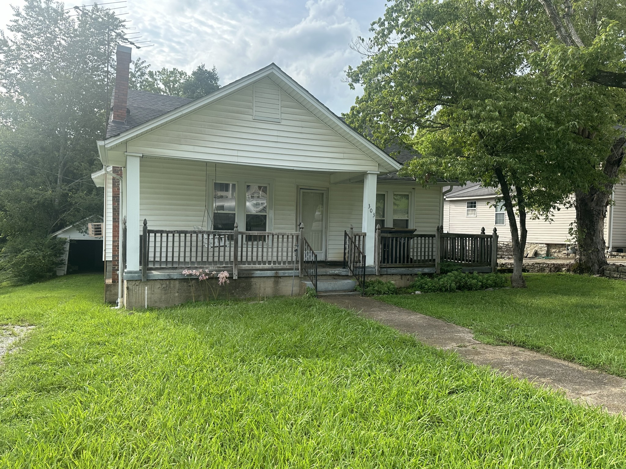 a view of a house with a yard and sitting area