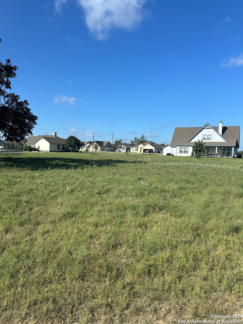 a view of a houses with a yard and lake view