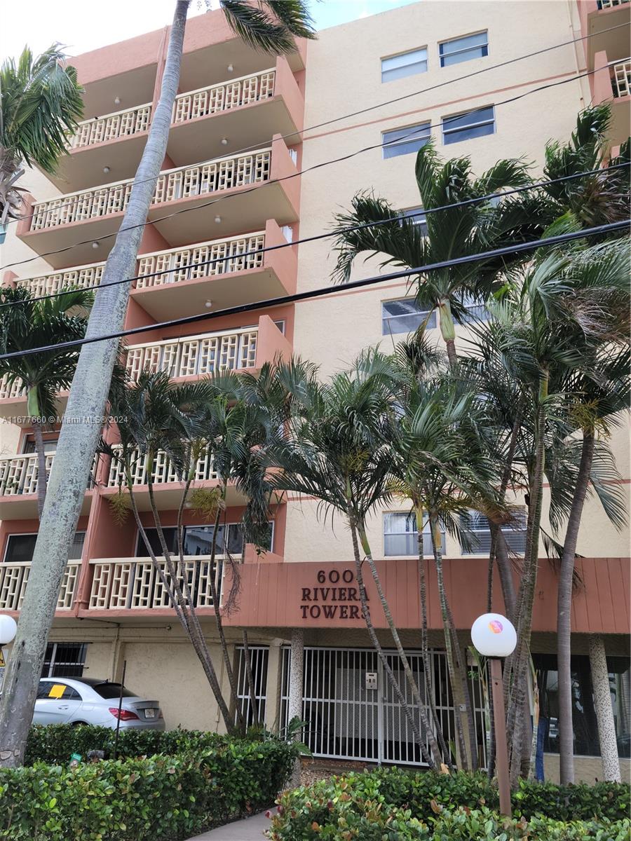 a view of a large building with a tree in the background