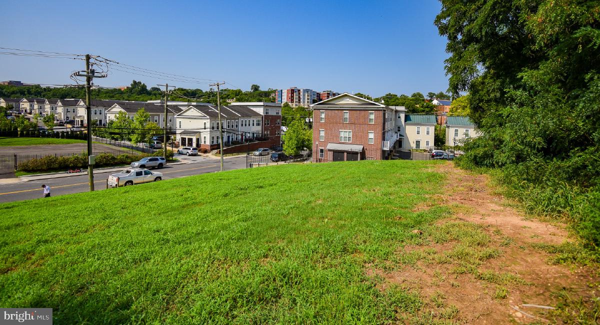 a view of a house with a big yard and large trees