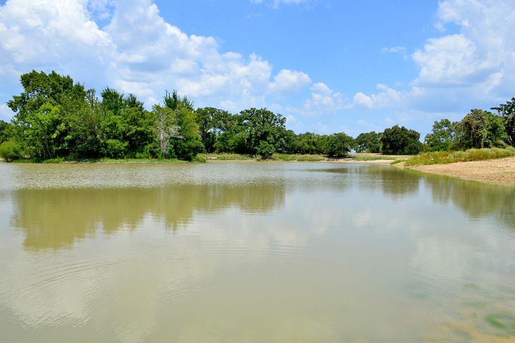 a view of a lake with houses in the back