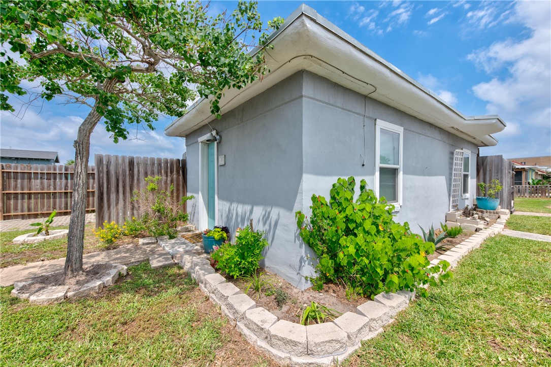 a house with a flower garden in front of it