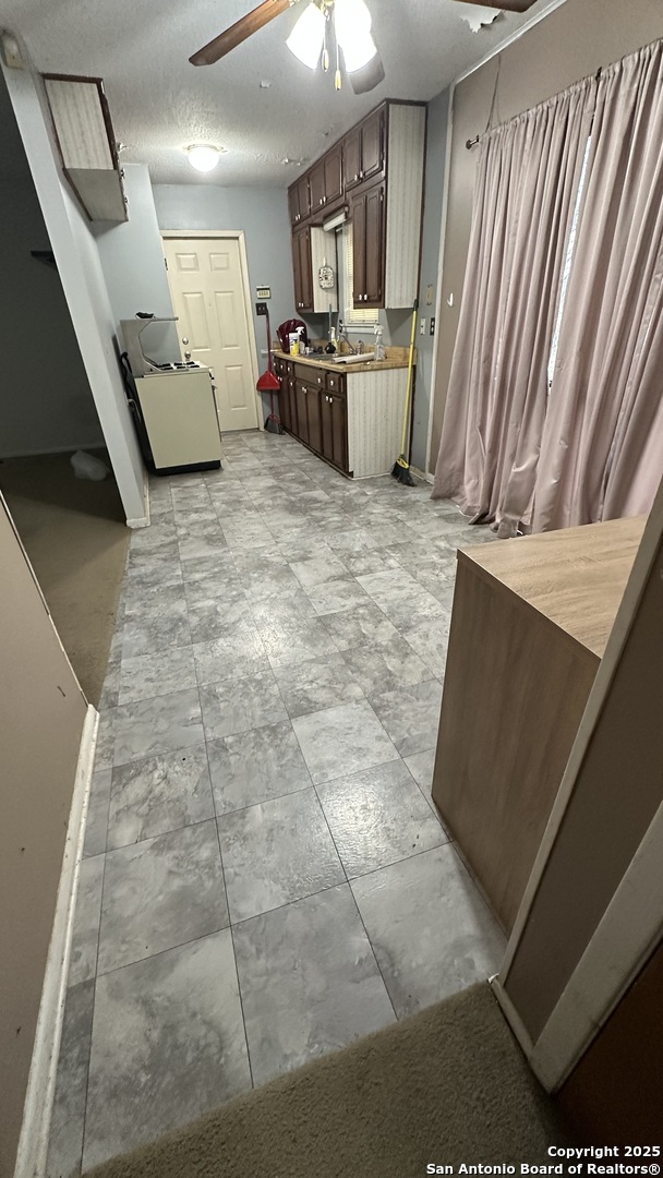 a view of a kitchen with microwave and cabinets