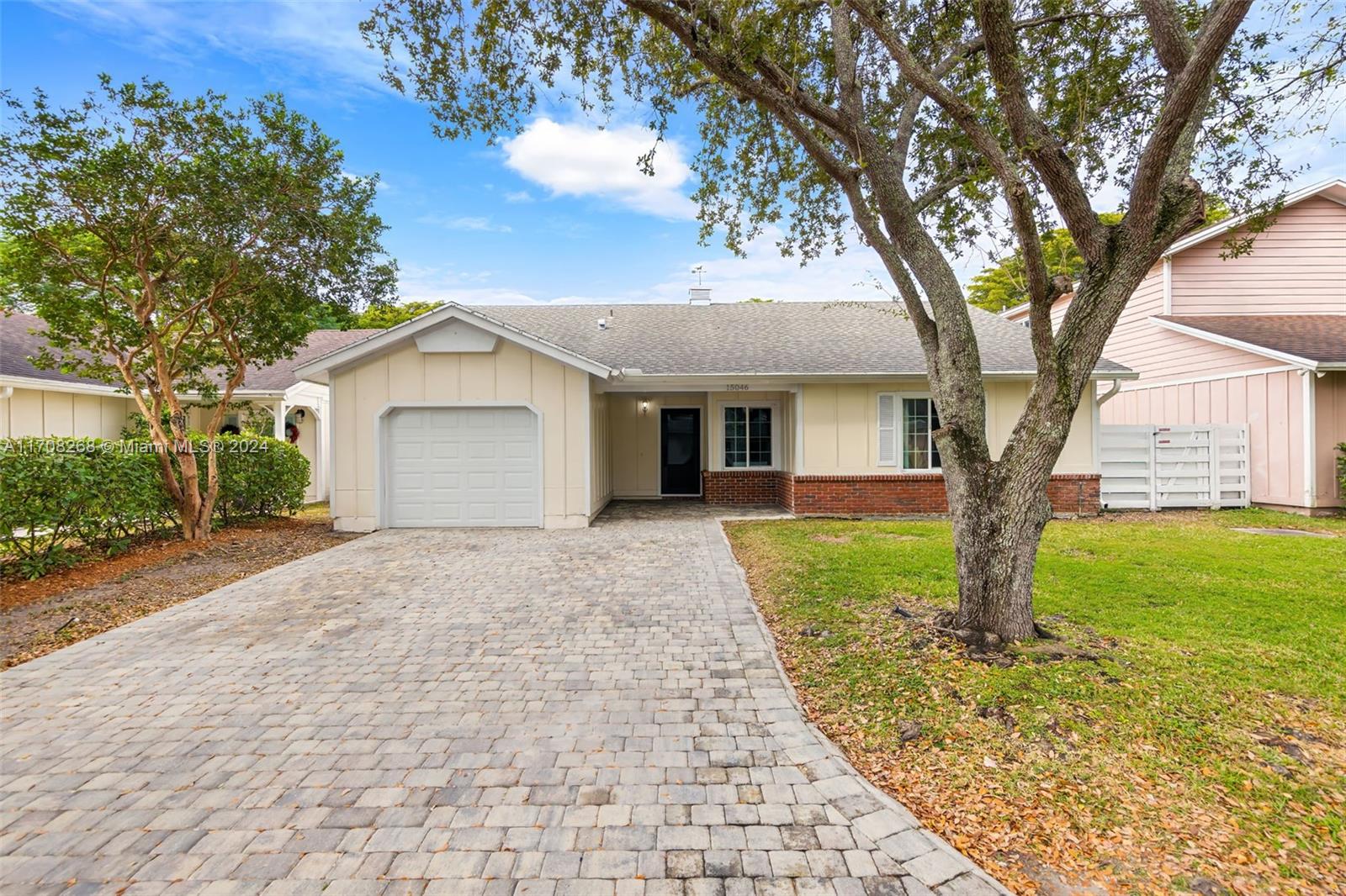 a view of a house with a tree in the yard