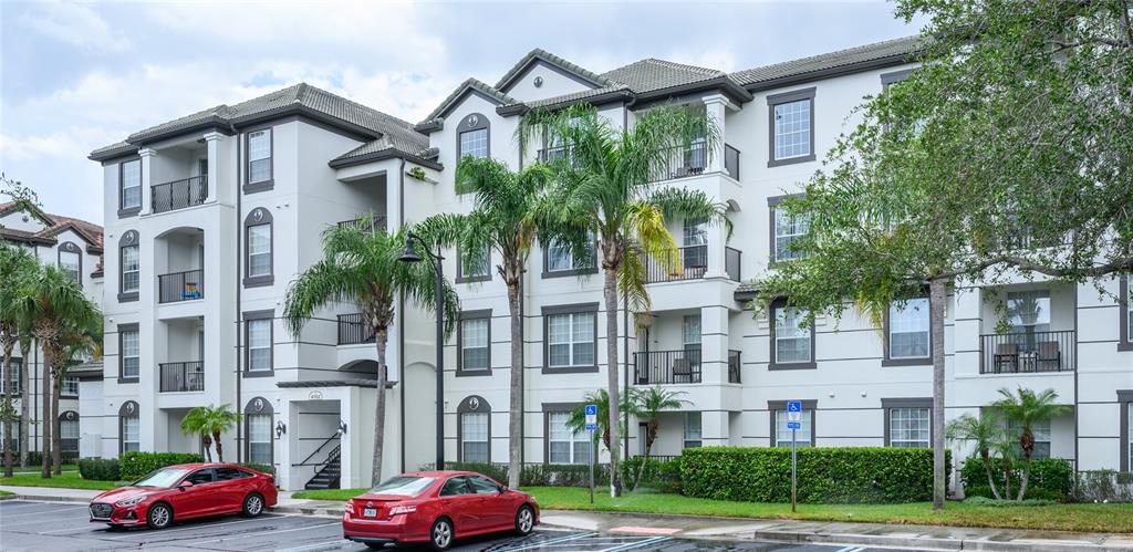 a front view of a residential apartment building with a yard