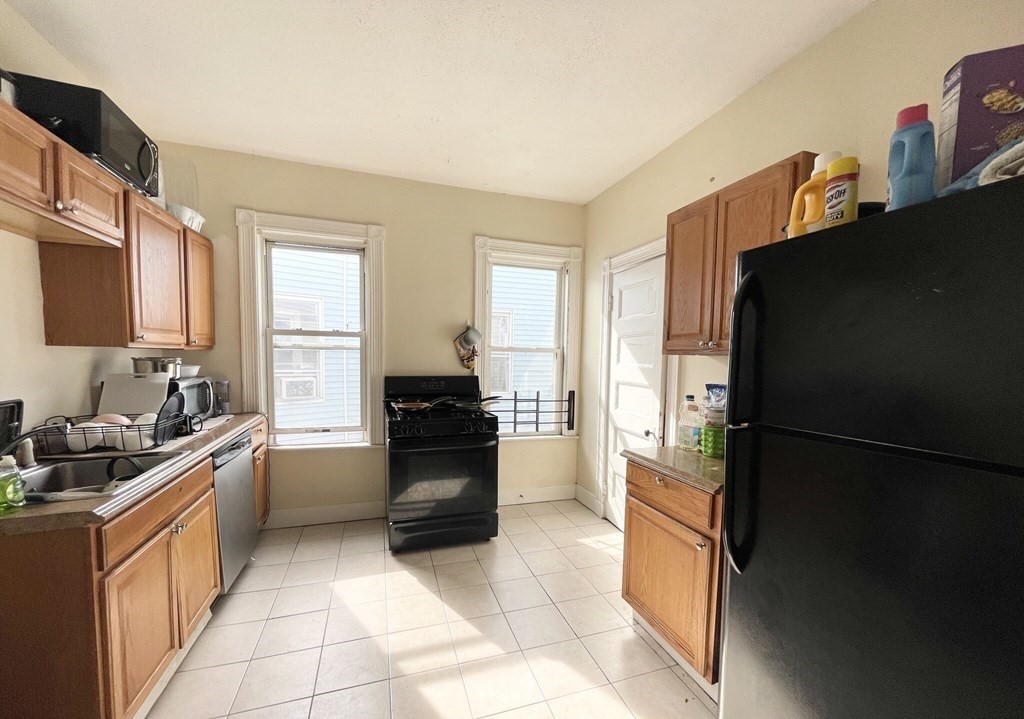 a kitchen with a refrigerator and a sink