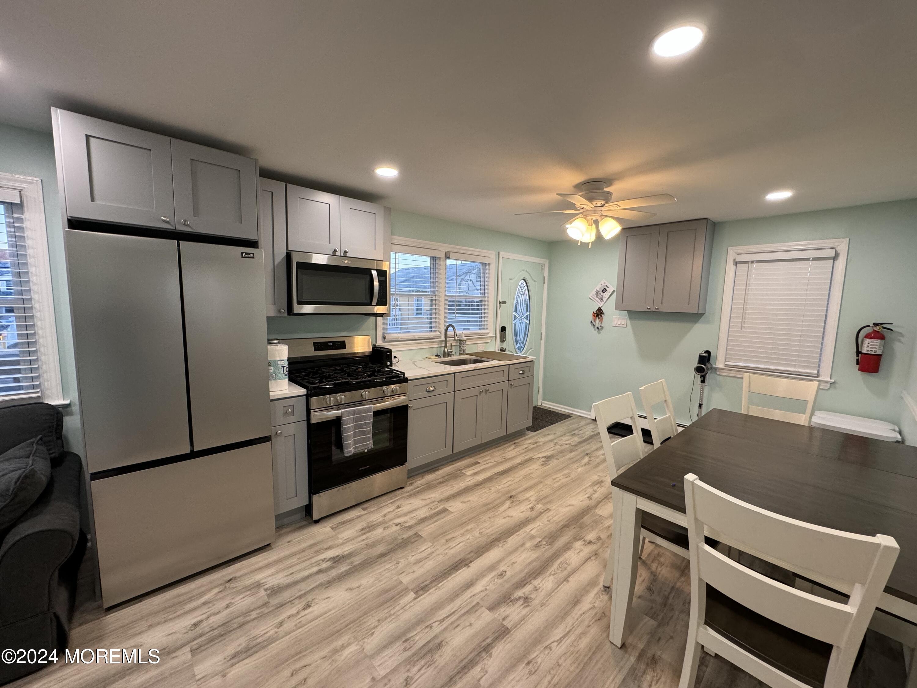 a kitchen with kitchen island a stove a sink and a refrigerator