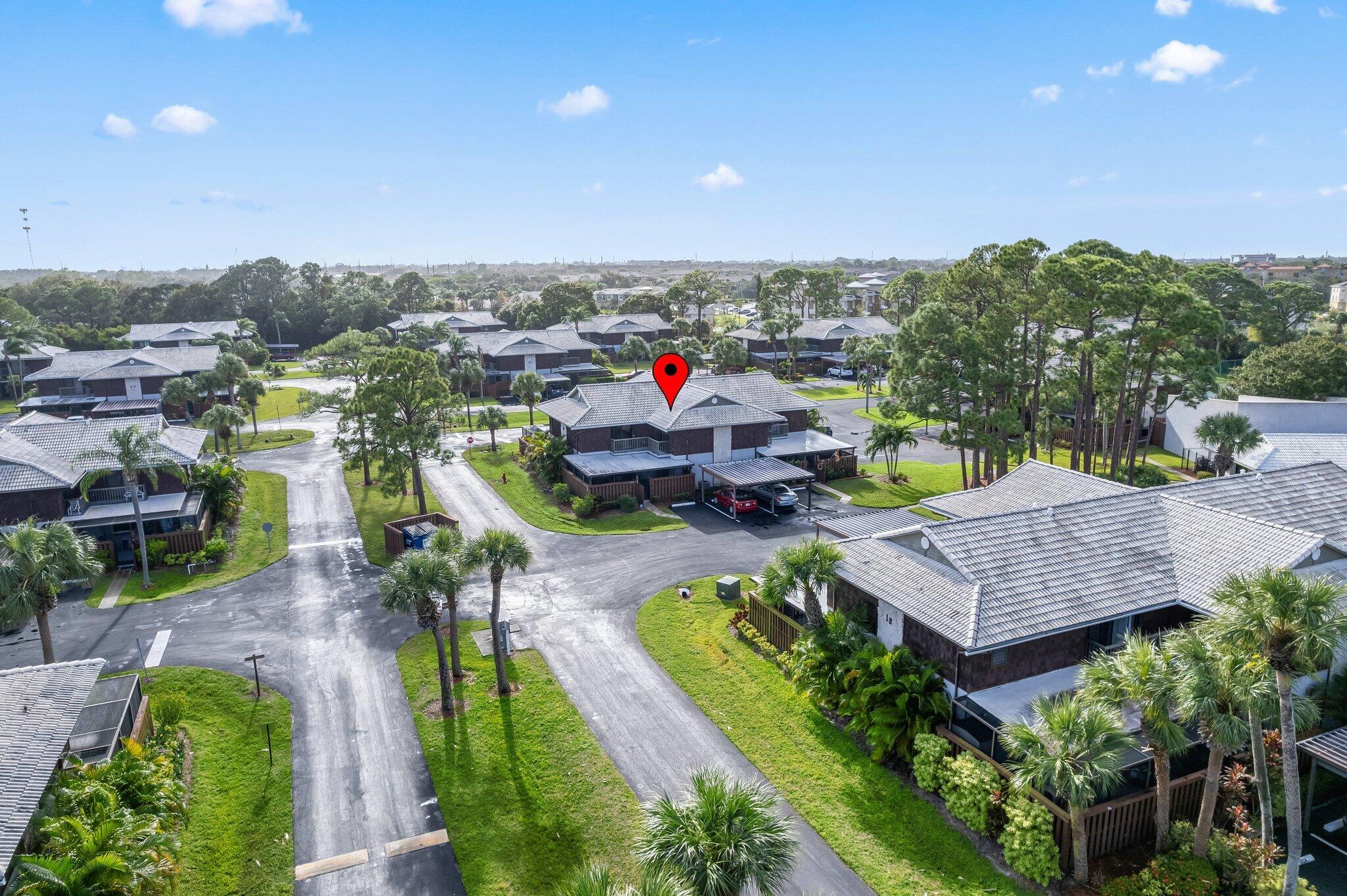 an aerial view of a house with swimming pool and a yard