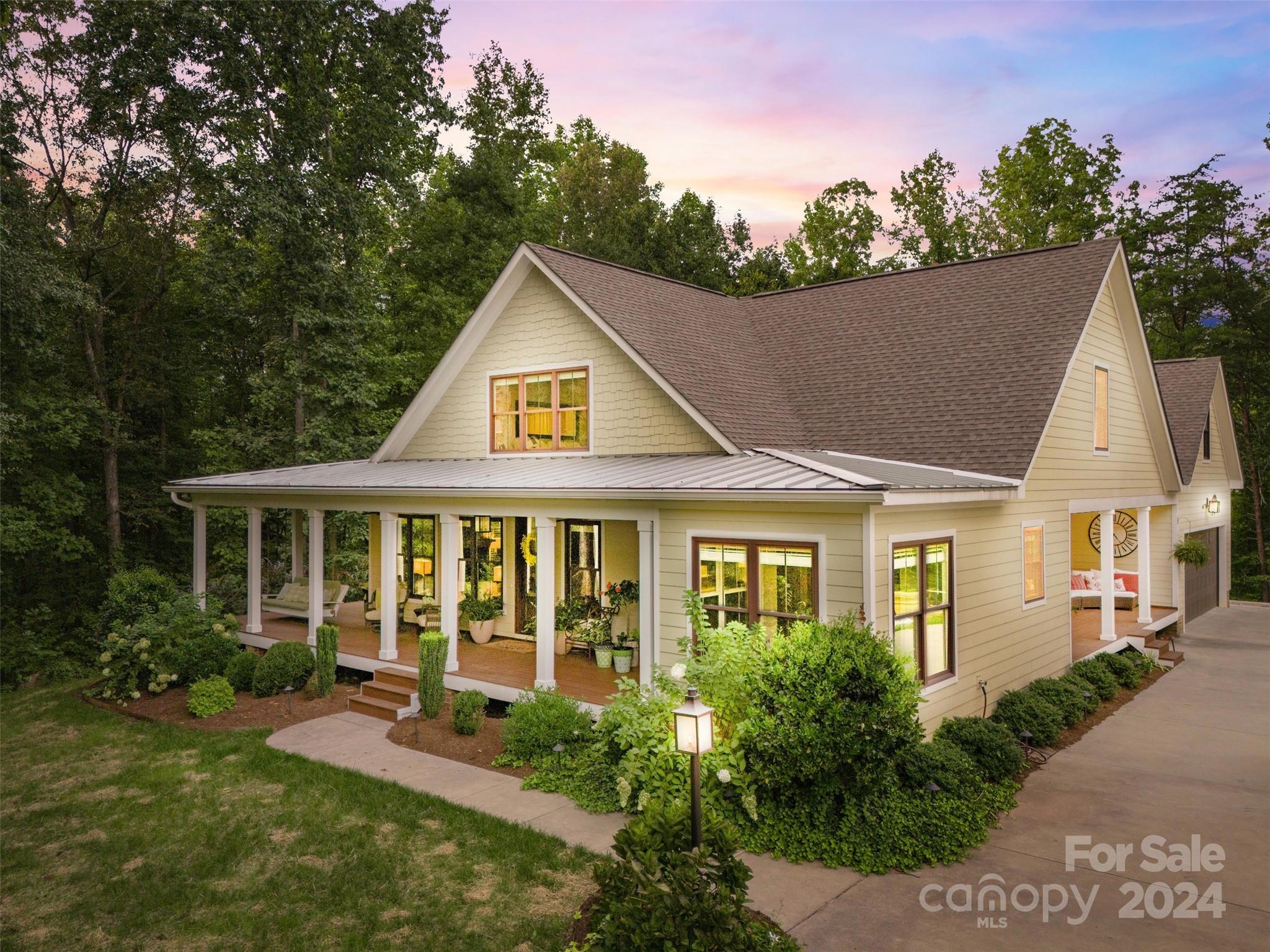 a view of a house with a yard and potted plants