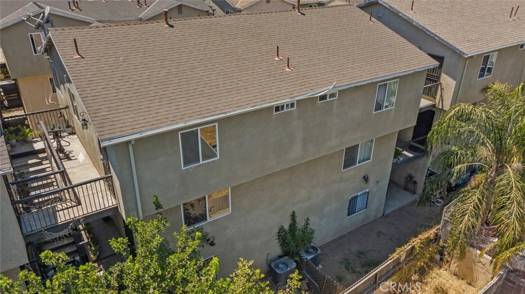 an aerial view of a house with a yard and potted plants