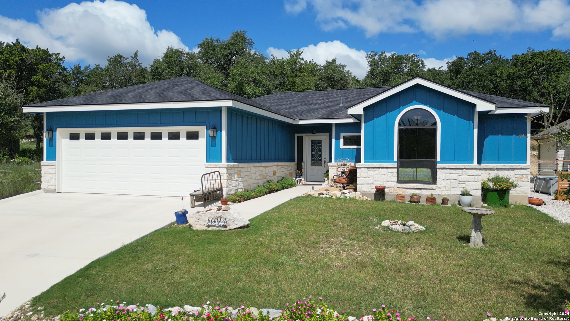 a front view of a house with garden