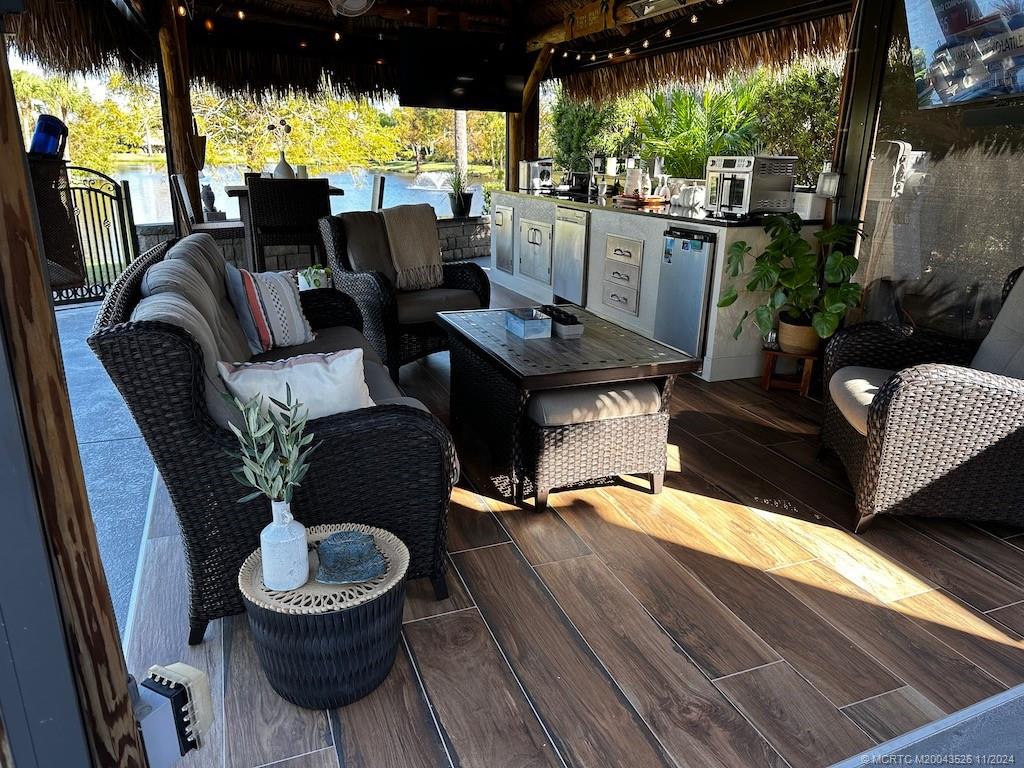 a living room with patio furniture and a floor to ceiling window