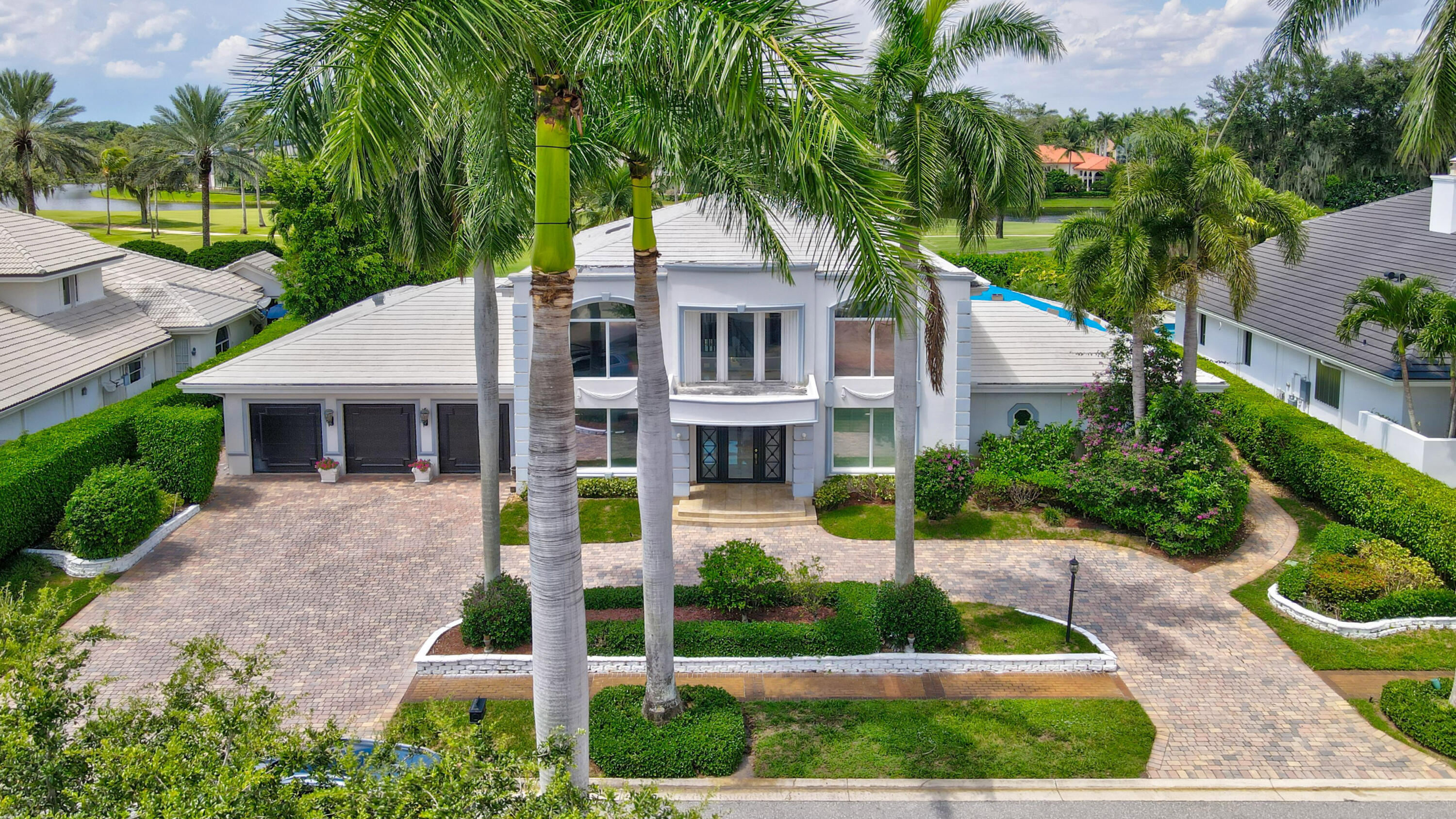 a front view of a house with a garden