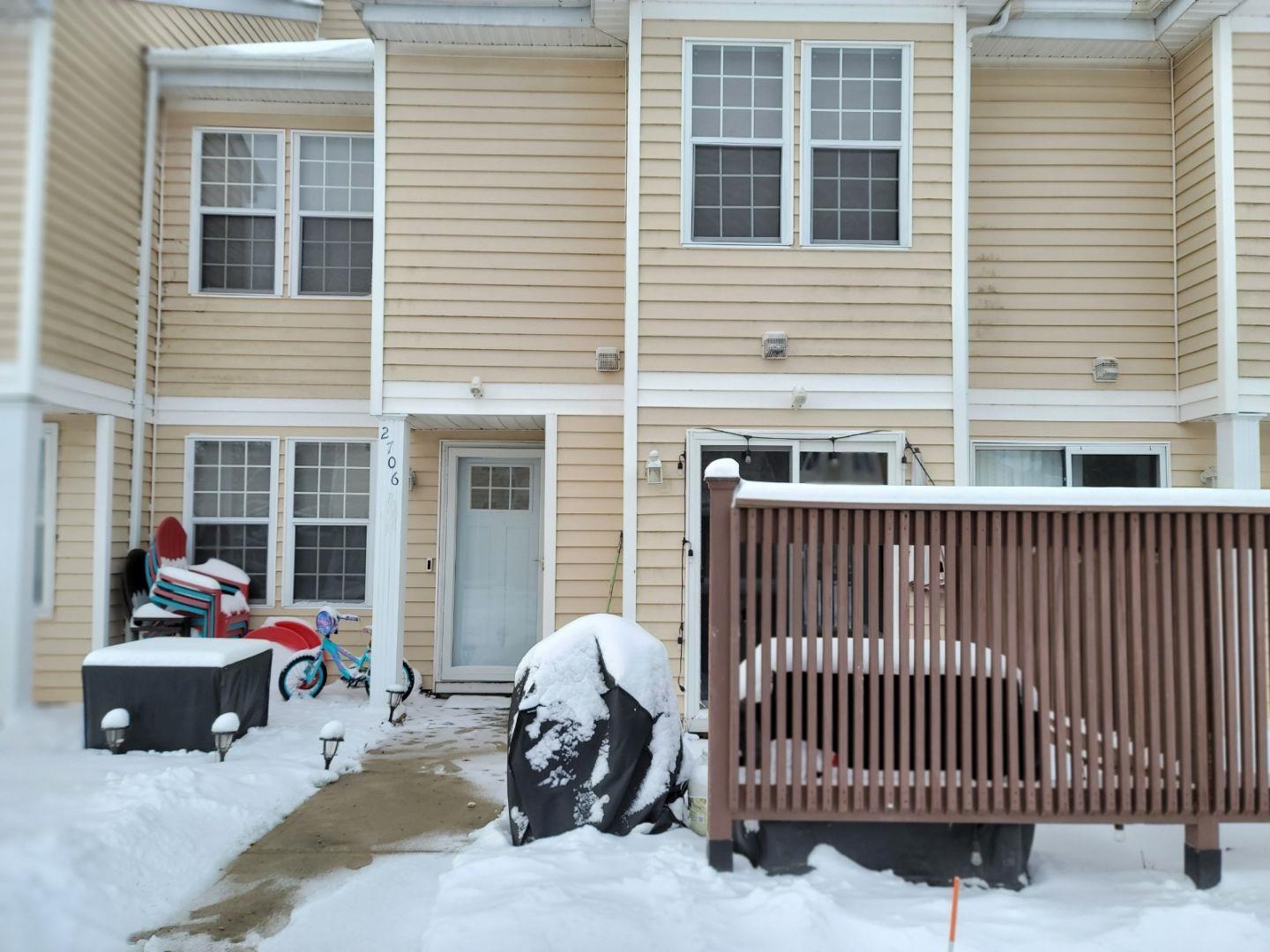 View of snow covered rear of property