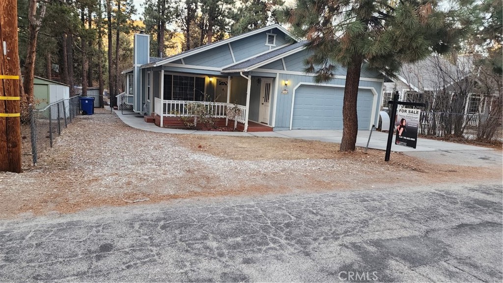 a view of a house with a yard covered in snow