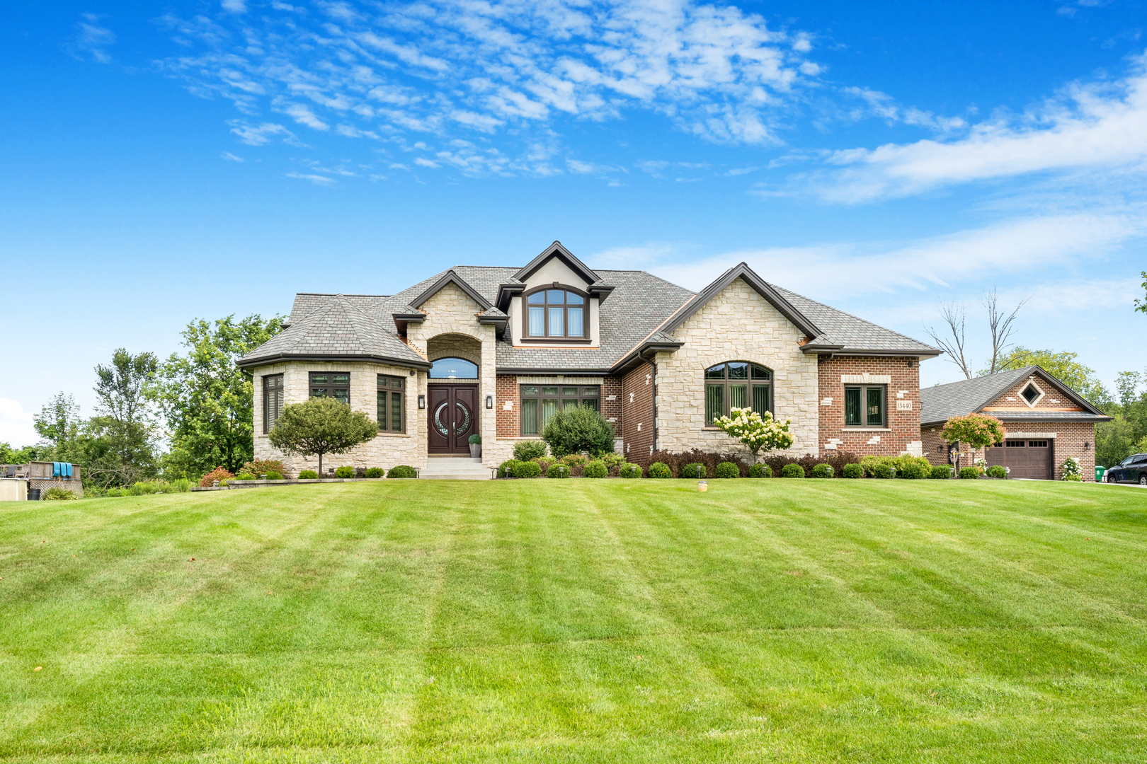 a front view of a house with a garden