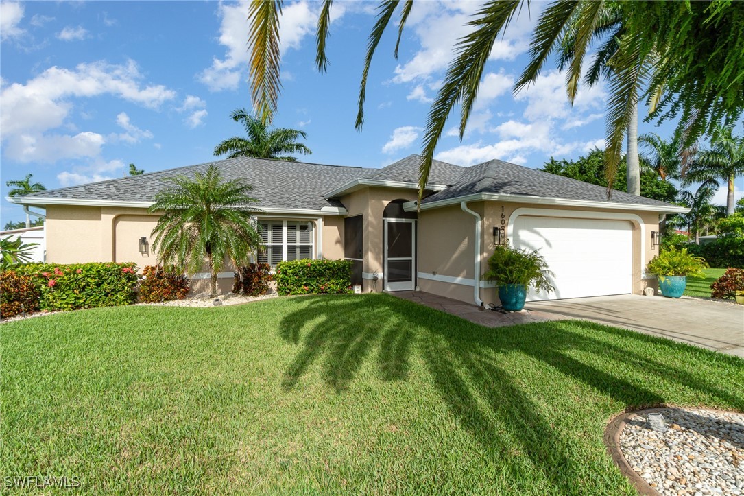 a front view of a house with a yard and potted plants