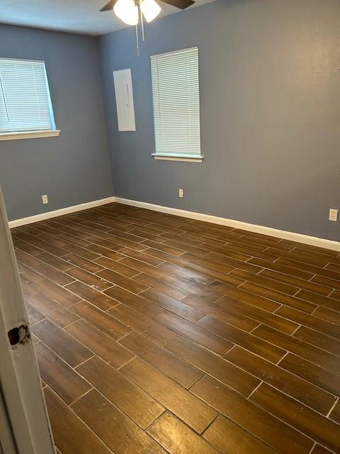 a view of an empty room with window and wooden floor