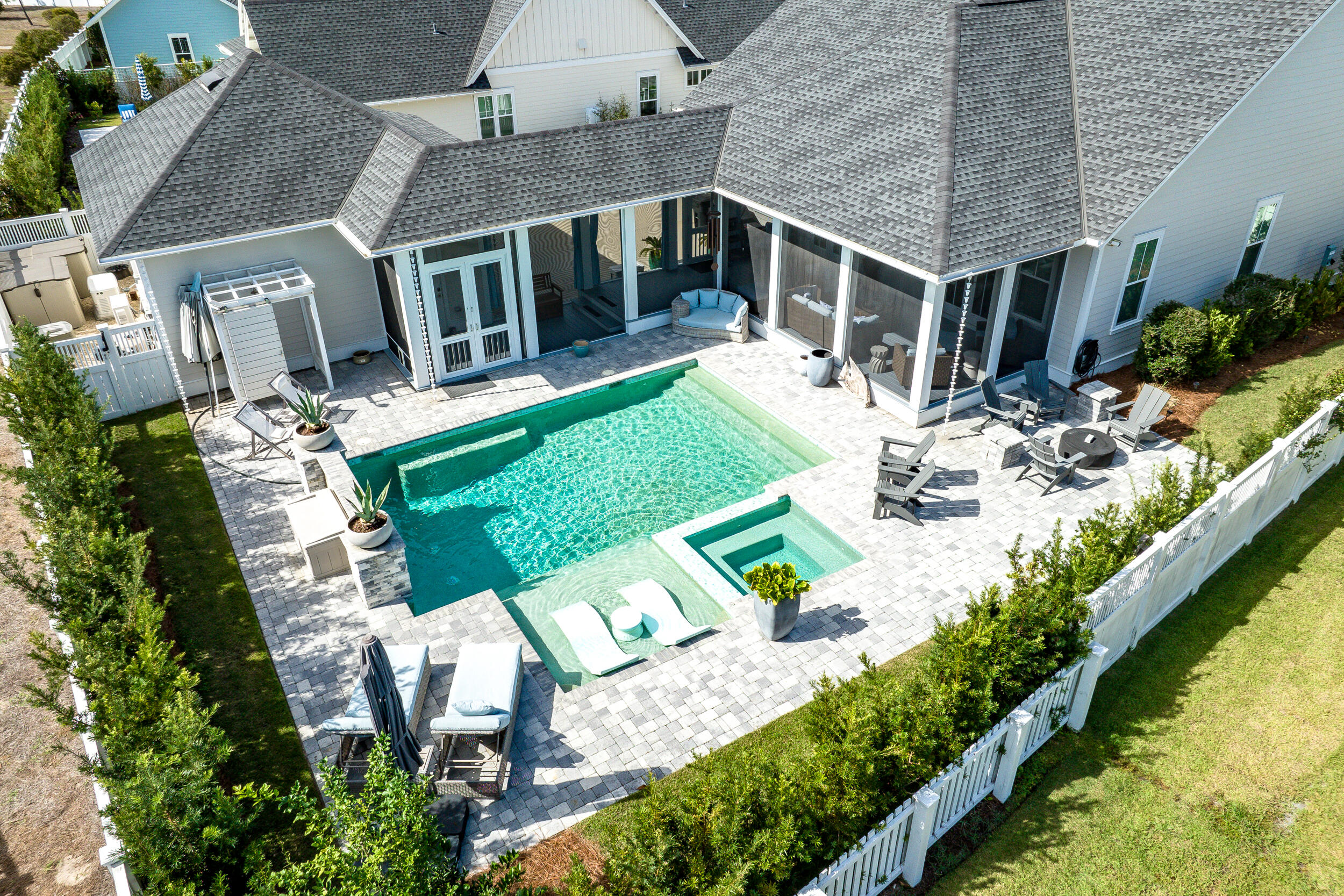 a view of house with a yard chairs and table in patio