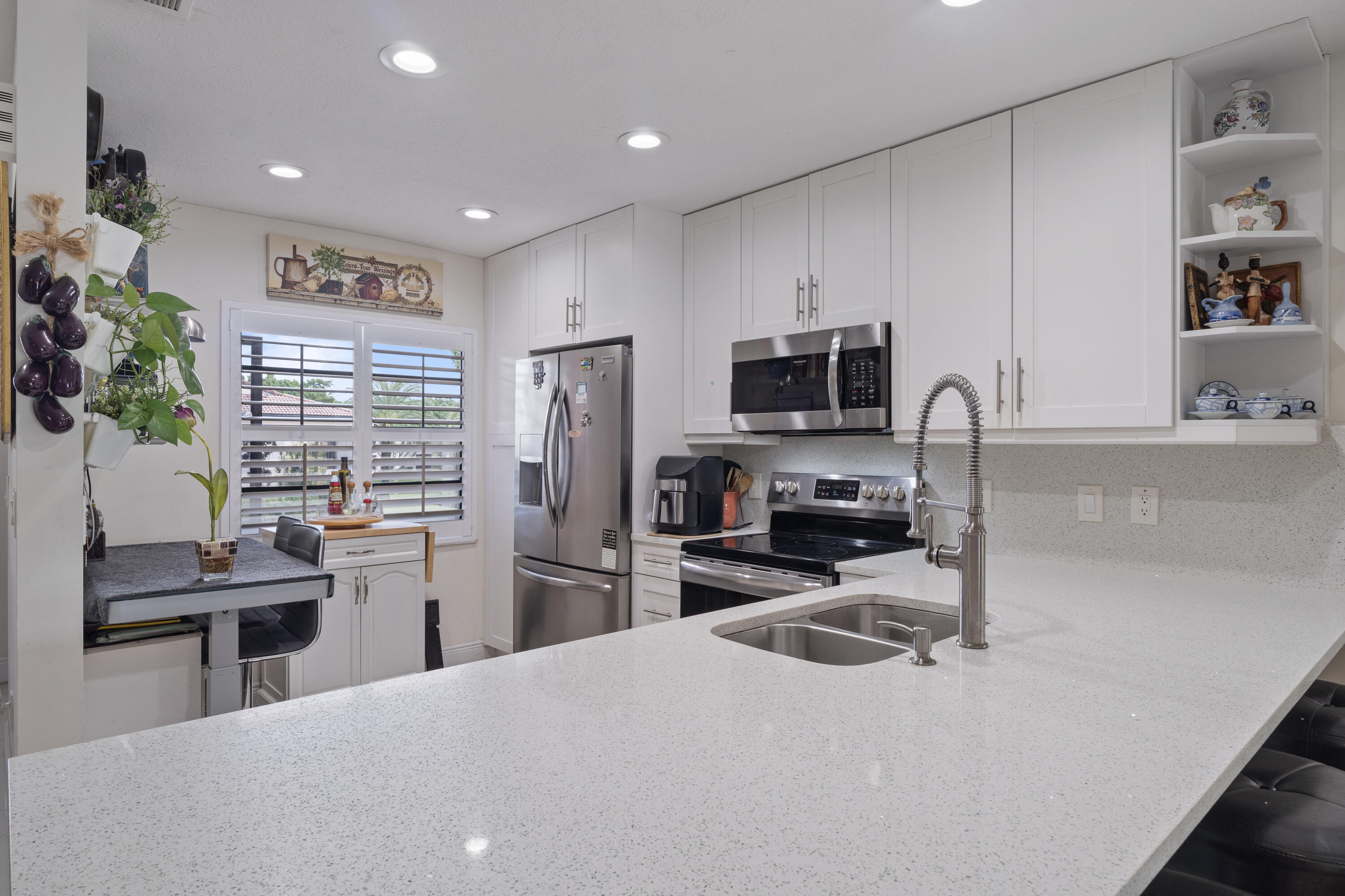 a kitchen with refrigerator and microwave