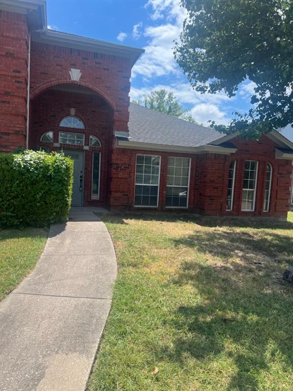 front view of a house with a yard