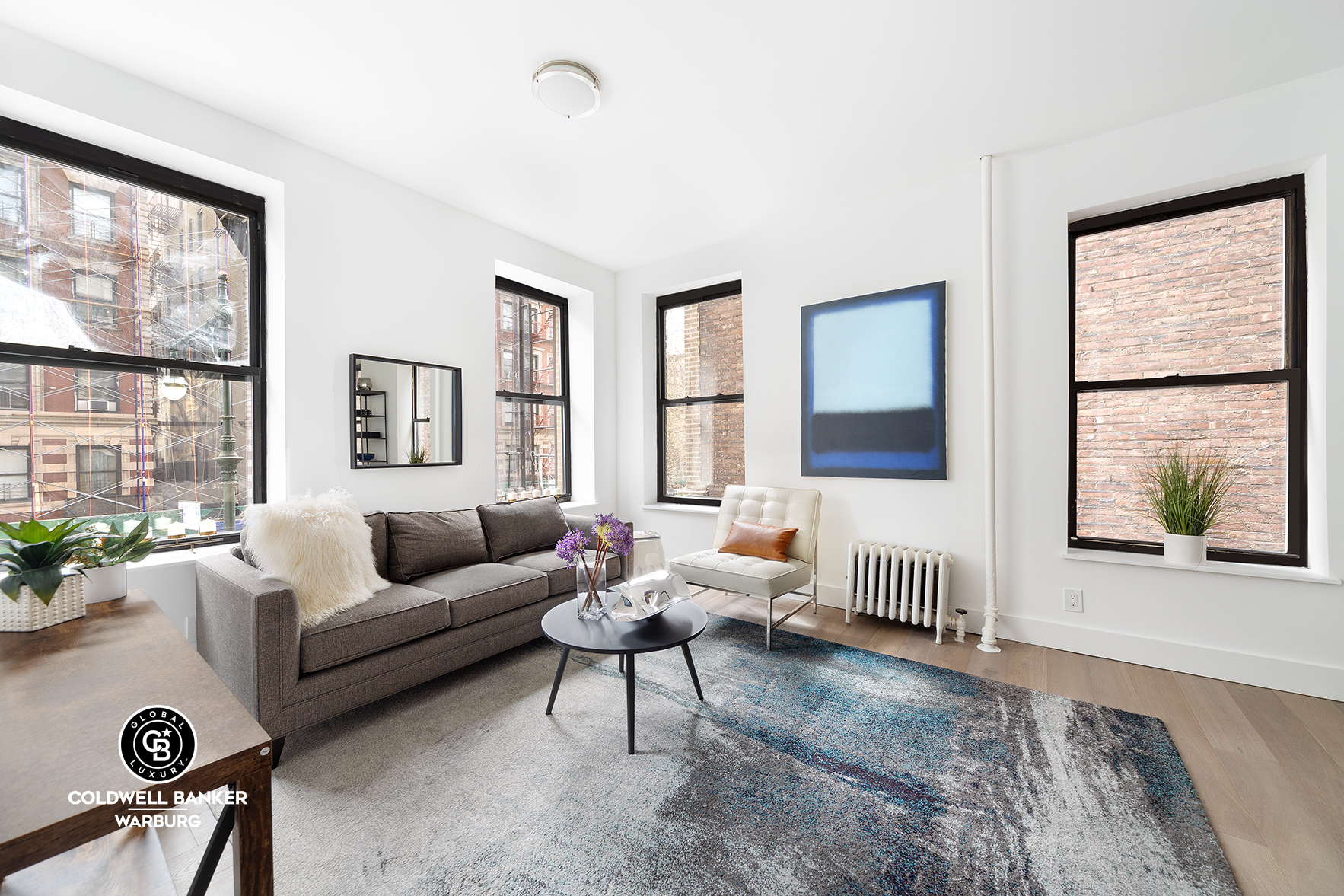 a living room with furniture rug and window