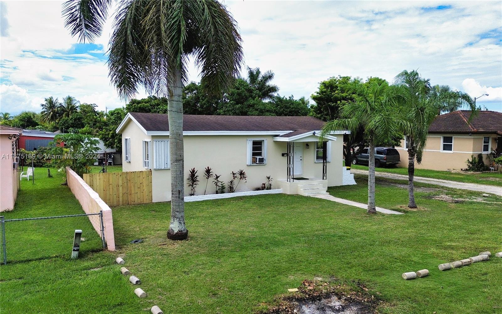 a view of a house with a yard deck and a slide