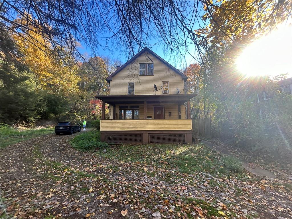 a view of house with backyard and trees