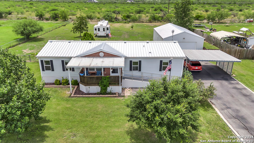 an aerial view of a house with swimming pool garden and patio