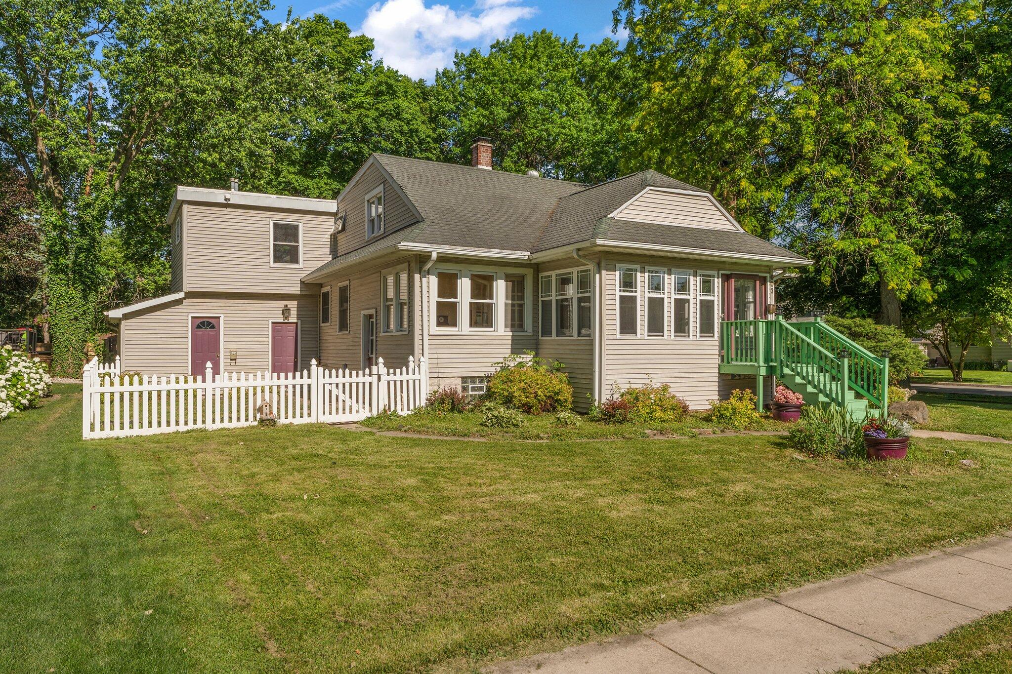 a front view of a house with a garden