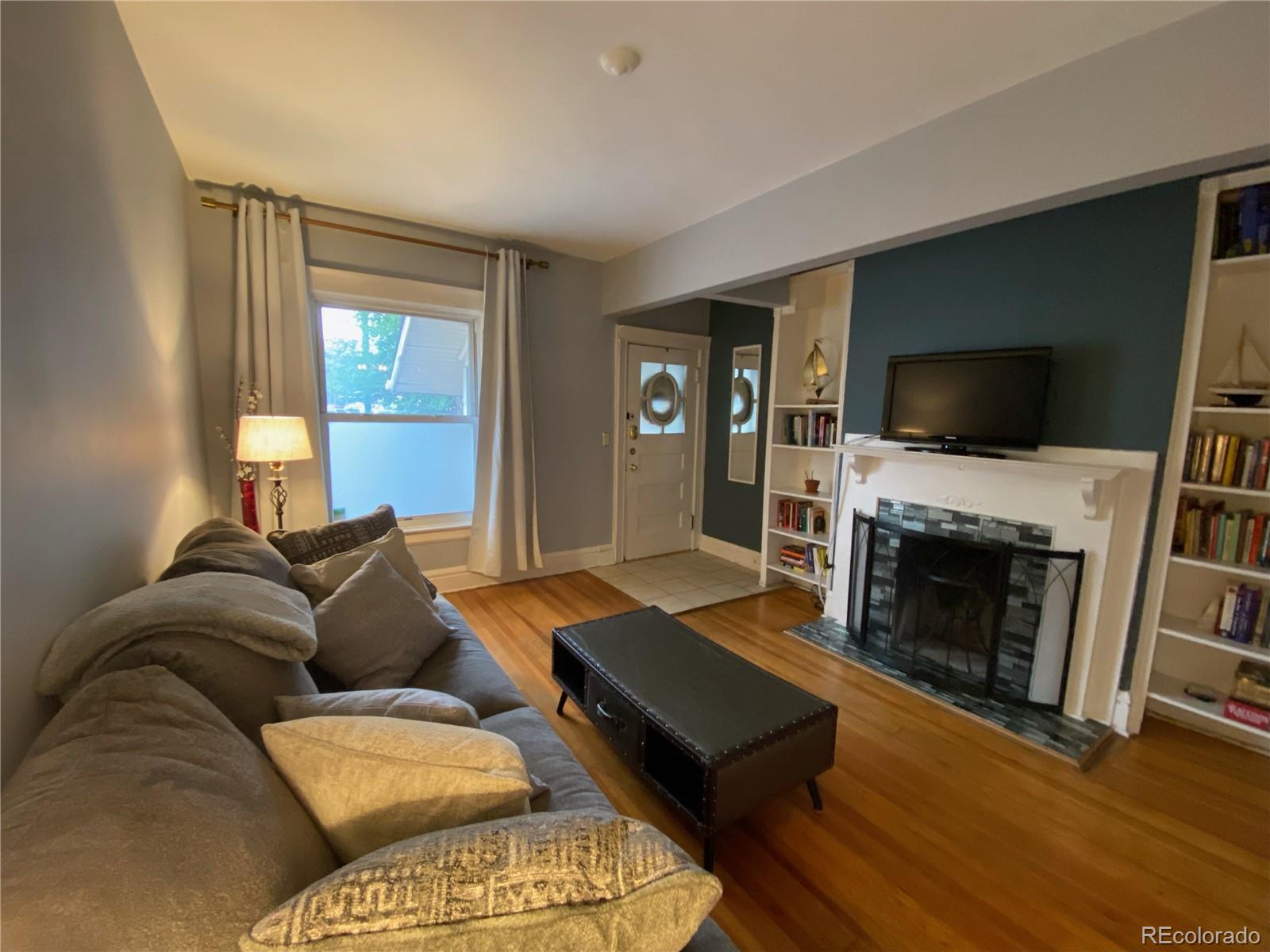 a living room with furniture flat screen tv and a fireplace