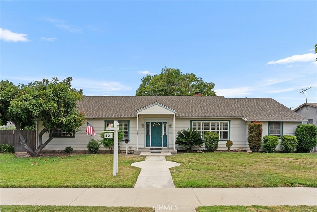 a front view of a house with a garden