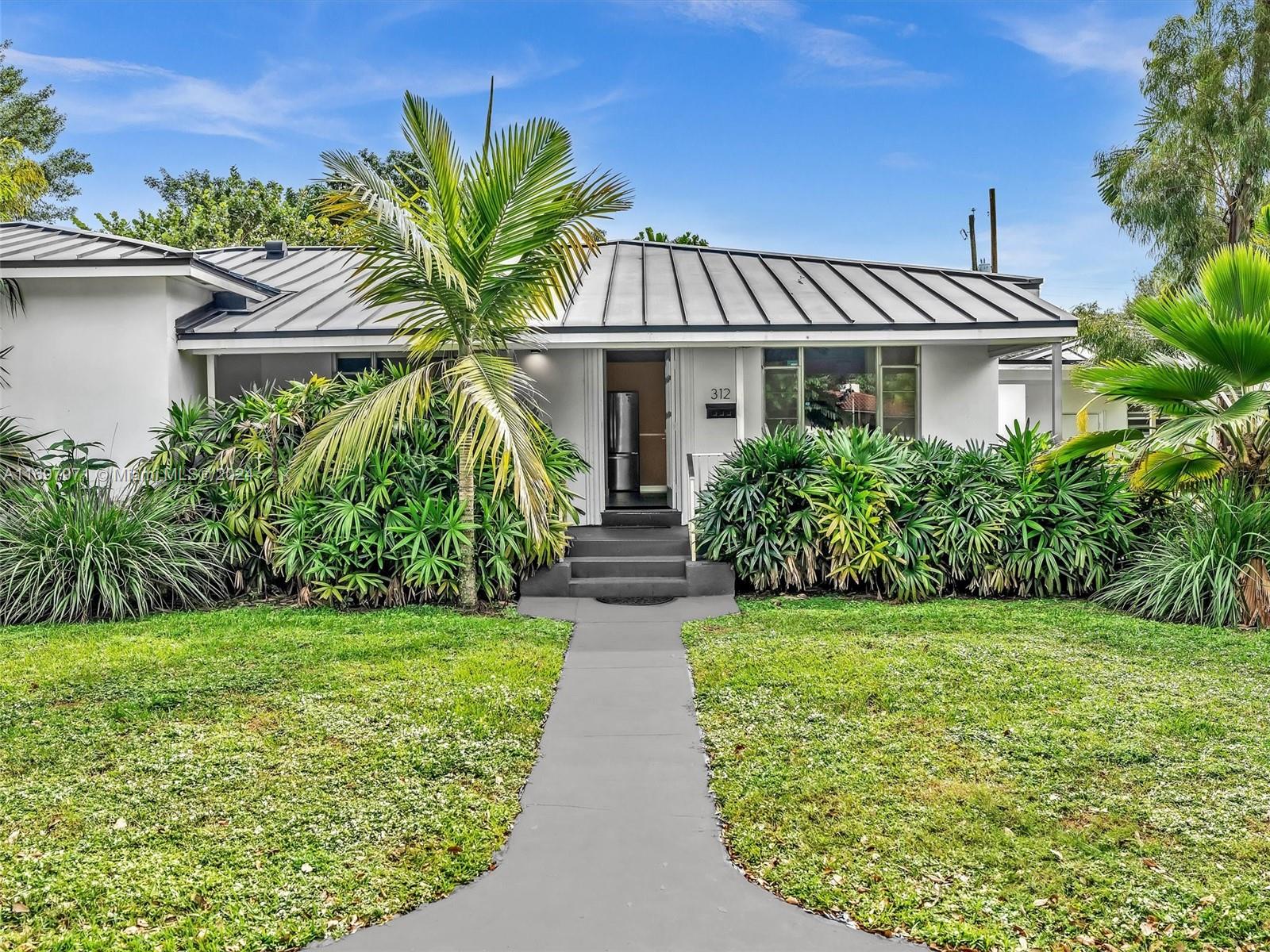 a front view of a house with garden