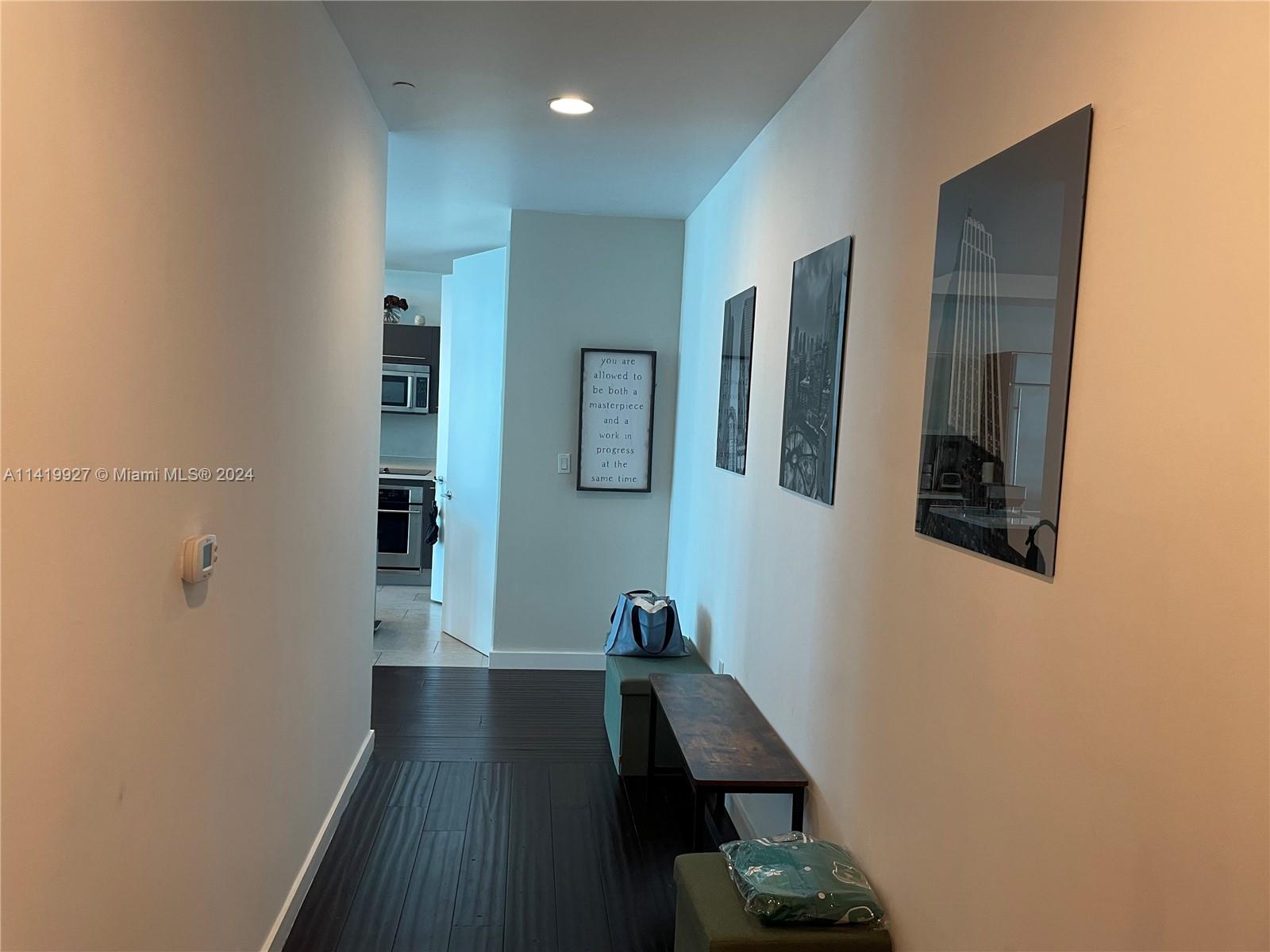 a view of hallway with wooden floor