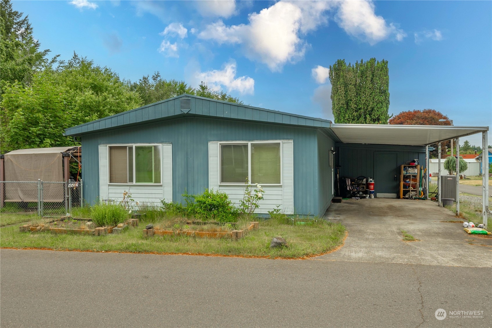 a front view of a house with a yard and potted plants