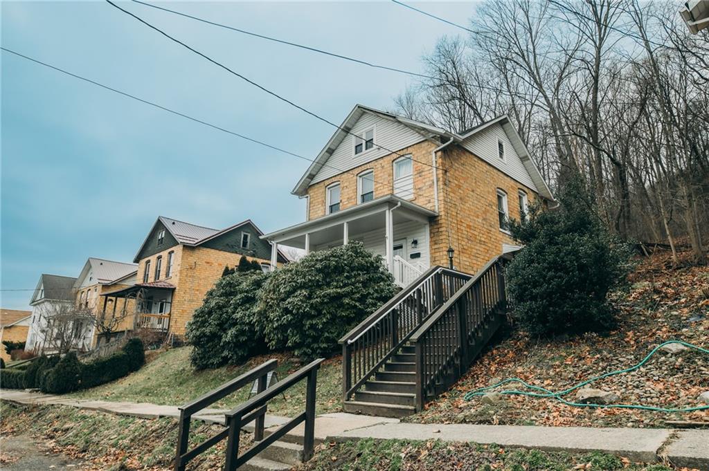 a house that has tree in front of it